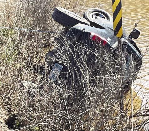 Pauls Valley firefighters used a winch line to keep this truck from rolling farther into Pauls Valley City Lake March 19 as crews worked to rescue the driver. Photo by Doug Walling/GCSO